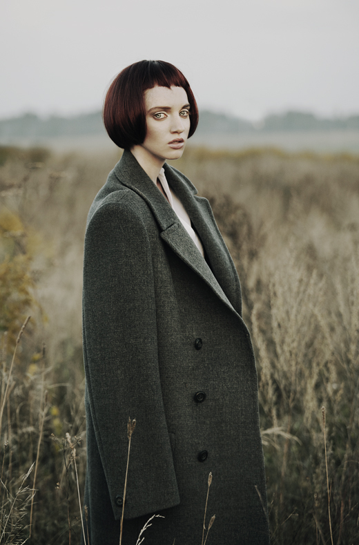 Girl wearing green coat | green coat, field, high grass, fog