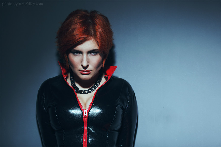 Vampire-like redhead standing against the wall | breasty girl, vampire, redhead, latex, blue wall