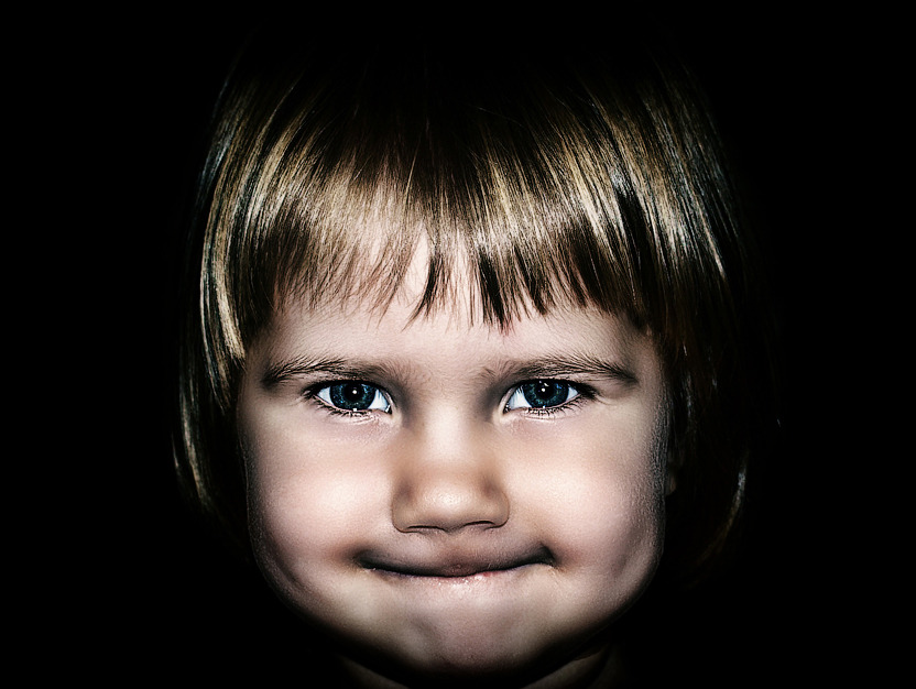 Portrait of a cute little girl primming lips | portrait, model, child, face, little girl, blonde, black background, prim lips, cute, fringe