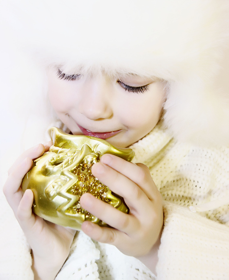 Smiling child with the golden souvenir | portrait, model, child, white, fur-cap, eyelashes, souvenir, New Year, golden, pullover