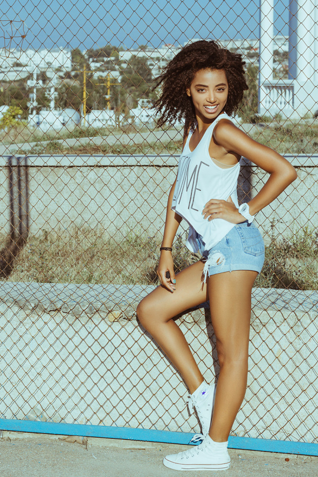 Cute laughing mulatto | portrait, model, cute girl, short hair, mulatto, wire netting, sunny day, smile, shorts, top